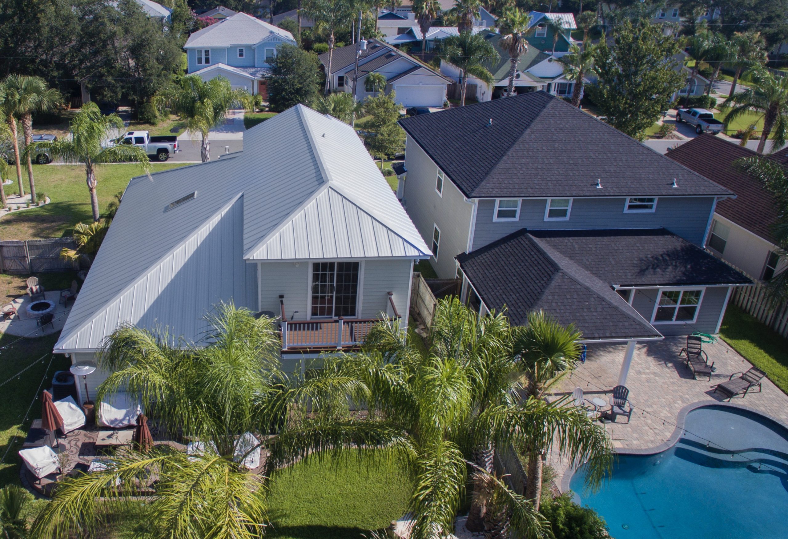 Aerial view of suburban homes with backyard pools.
