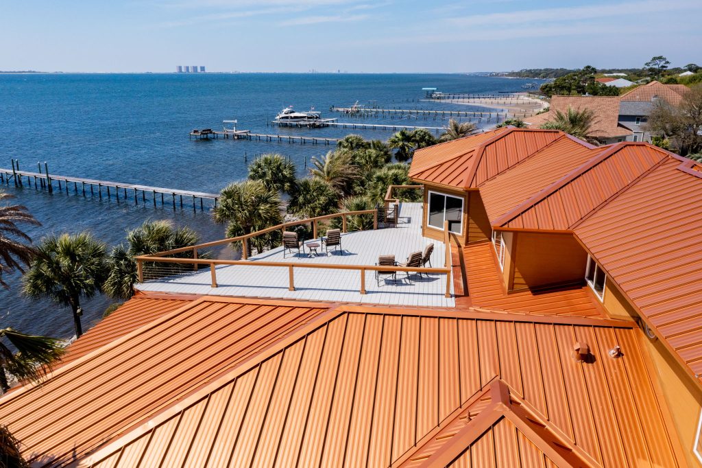 Orange roof house with ocean and pier view.