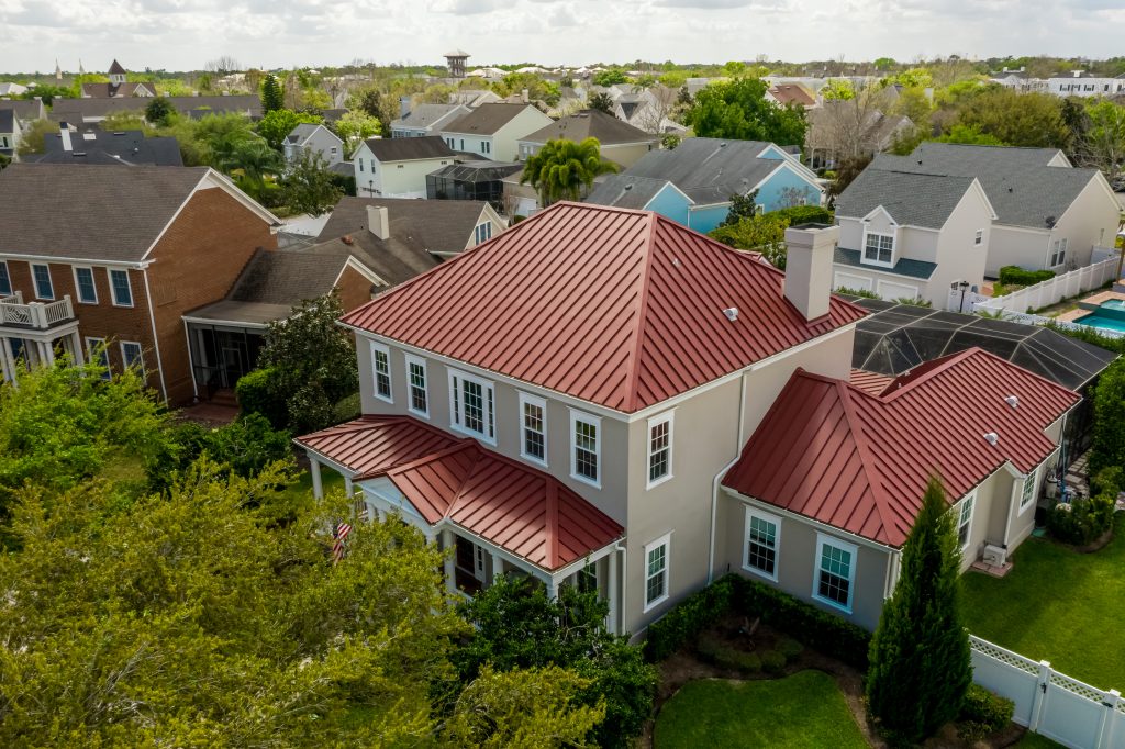Aerial view of suburban houses with red roofs.