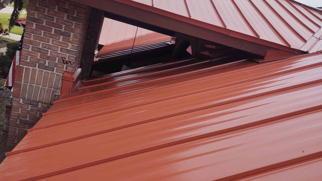 Red metal roof and brick wall detail