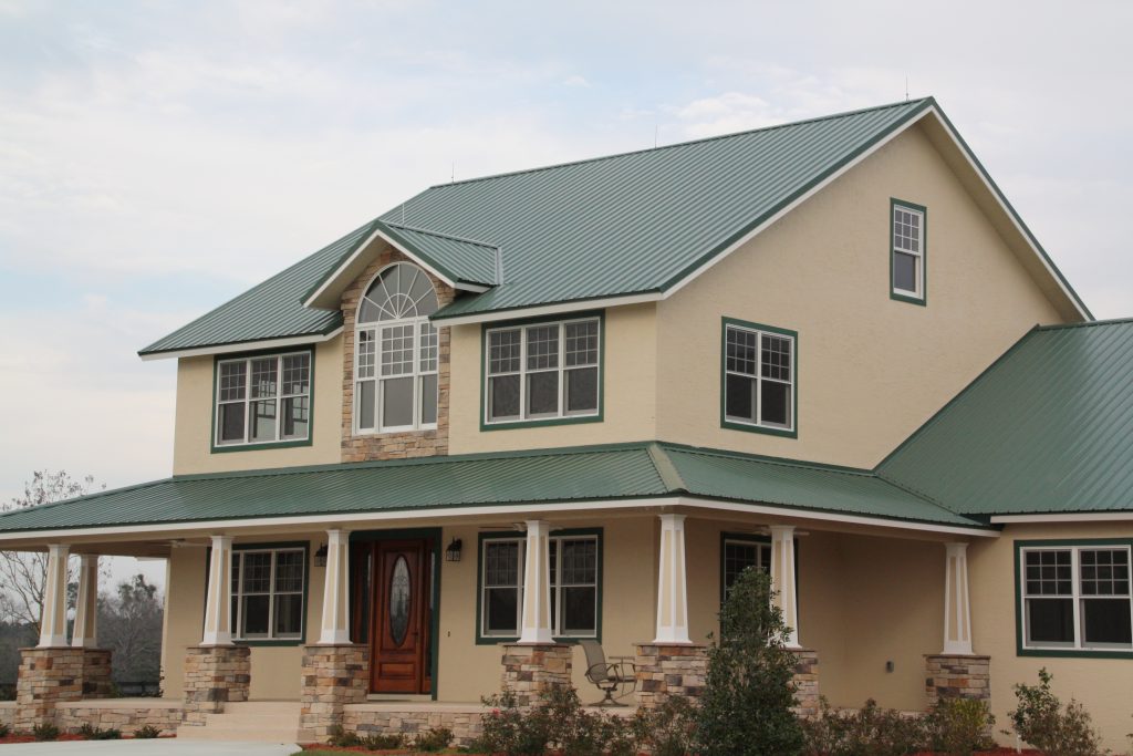 Two-story house with green metal roof